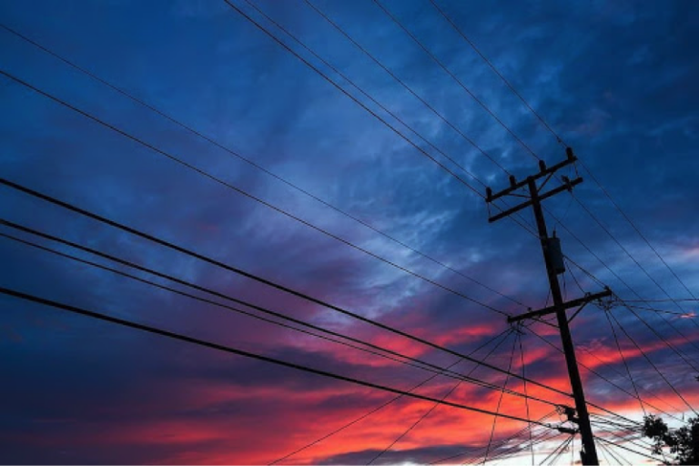 Electrical lines against sunset