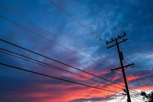 Electrical lines against a sunset